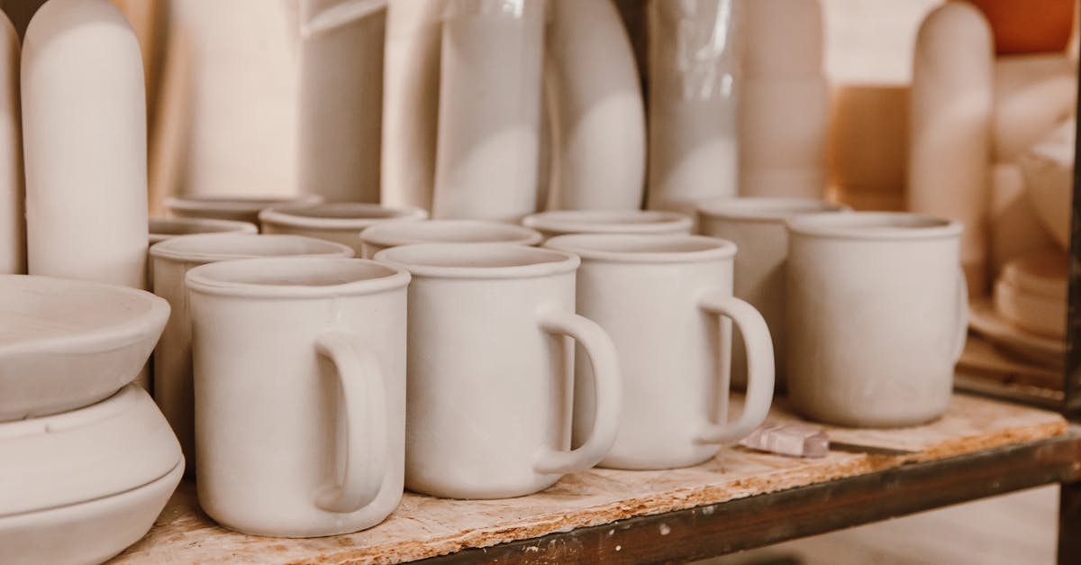 Handmade ceramic mugs arranged on a shelf