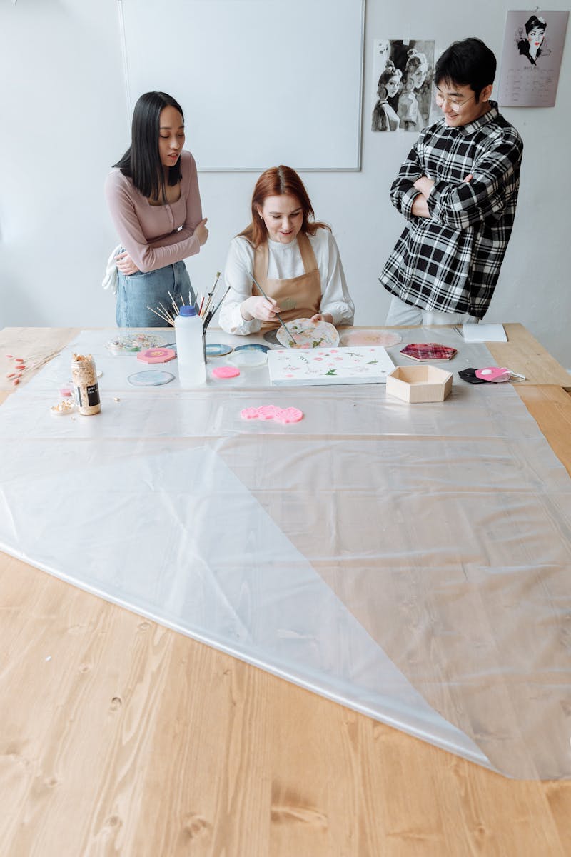 People painting together at a studio worktable