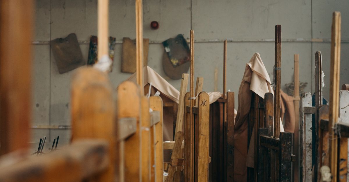 A cozy art studio with wooden easels and canvases