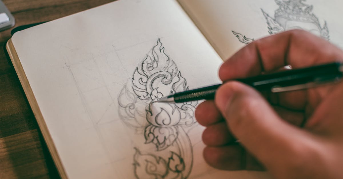 A hand sketching in a sketchbook