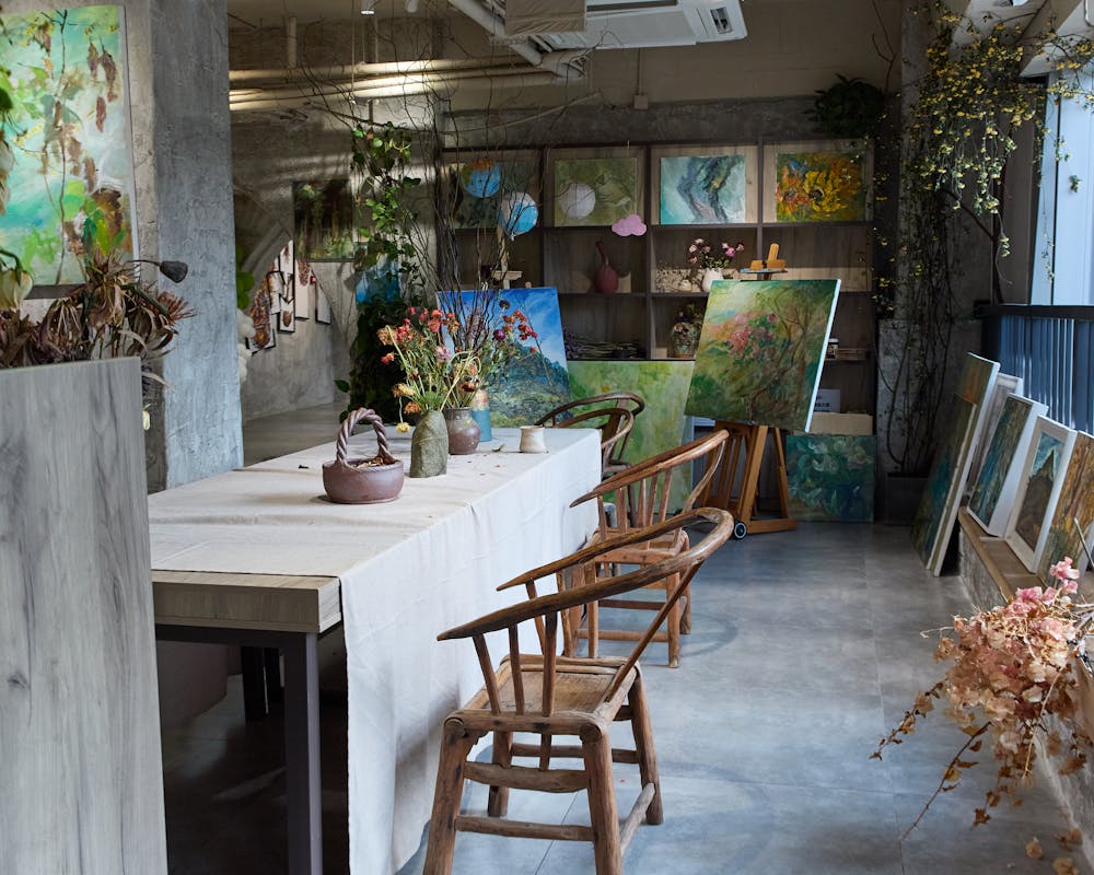 A bright, inviting art studio filled with colorful work